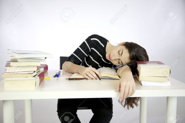 13196456 lazy girl falls asleep while studying surrounded by books